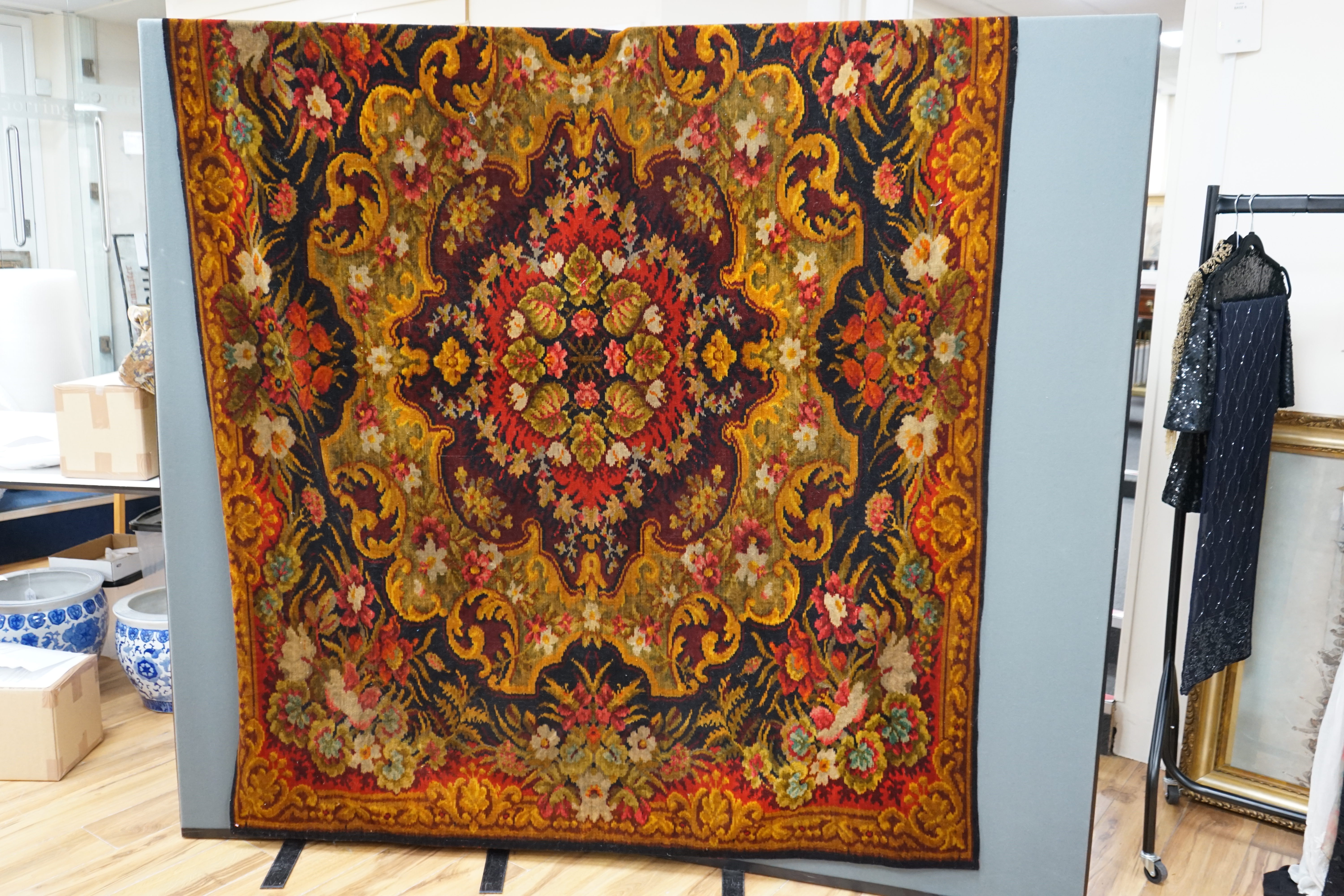 An Edwardian table cover in brightly coloured wools, with a floral design, together with a later 20th century continental grey, beige and cream patterned silk cover, Edwardian table cover 220cm x 172cm. Condition - colou